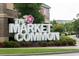 The Market Common sign surrounded by lush landscaping, indicating a popular shopping destination at 1424 Powhaton Dr., Myrtle Beach, SC 29577