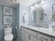 Elegant bathroom featuring blue walls, modern fixtures, and granite countertop vanity at 1425 S Ocean Blvd. # 7C, North Myrtle Beach, SC 29582