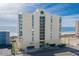 Exterior view of the condo building with parking, and beach access at 1425 S Ocean Blvd. # 7C, North Myrtle Beach, SC 29582