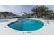 Community pool features clear blue water surrounded by lounge chairs, umbrellas and manicured lawns at 1500 Deer Creek Rd. # C, Surfside Beach, SC 29575