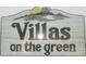 Community sign reading 'Villas on the Green' along with a golf green and flag in the background at 1500 Deer Creek Rd. # C, Surfside Beach, SC 29575