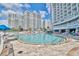 Enjoy the outdoor pool and seating with a view of the condos at 158 Seawatch Dr. # 1112, Myrtle Beach, SC 29572