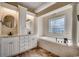 Bathroom with double vanity, soaking tub, and tile flooring at 1585 Brookgreen Dr., Myrtle Beach, SC 29577