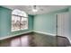 Bedroom with hardwood floors, large arched window, and neutral paint at 1585 Brookgreen Dr., Myrtle Beach, SC 29577