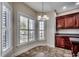 Cozy dining area with tiled floor, plantation shutters, and a view of the outside greenery through the window at 1585 Brookgreen Dr., Myrtle Beach, SC 29577