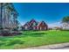 Traditional two-story brick home with manicured lawn and mature landscaping at 1585 Brookgreen Dr., Myrtle Beach, SC 29577