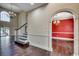Spacious foyer showcasing hardwood floors, staircase with white railing, and archway leading to dining room at 1585 Brookgreen Dr., Myrtle Beach, SC 29577
