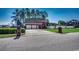 Side view of brick house, showcasing a three-car garage with spacious driveway and manicured lawn at 1585 Brookgreen Dr., Myrtle Beach, SC 29577