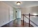 Hallway with hardwood flooring and stairway with white wooden spindles at 1585 Brookgreen Dr., Myrtle Beach, SC 29577