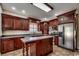 Kitchen features include an island, stainless steel appliances, and dark wood cabinets with light countertops at 1585 Brookgreen Dr., Myrtle Beach, SC 29577