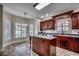 Open kitchen with dark wood cabinets, stainless steel appliances, and a central island at 1585 Brookgreen Dr., Myrtle Beach, SC 29577