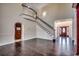 Spacious living room featuring a staircase, hardwood floors, and a decorative front door at 1585 Brookgreen Dr., Myrtle Beach, SC 29577