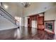 Spacious living room with hardwood floors, fireplace, and built-in bookcase, with a staircase in view at 1585 Brookgreen Dr., Myrtle Beach, SC 29577