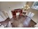 Open-concept living room with hardwood floors, built-in shelves, fireplace, and large windows at 1585 Brookgreen Dr., Myrtle Beach, SC 29577