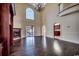 Bright living room featuring hardwood floors, fireplace, and large window with sliding glass door at 1585 Brookgreen Dr., Myrtle Beach, SC 29577