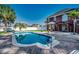 Backyard pool with brick patio, palm trees, and view of the home's exterior at 1585 Brookgreen Dr., Myrtle Beach, SC 29577