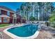 Inviting in-ground pool surrounded by a brick patio, palm trees, and lush landscaping at 1585 Brookgreen Dr., Myrtle Beach, SC 29577