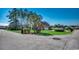 Residential street view featuring a well-manicured home with a spacious front yard at 1585 Brookgreen Dr., Myrtle Beach, SC 29577