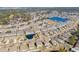 A high angle aerial view shows the community has winding streets, lakes, ponds, pools, and landscaped homes at 160 Ocean Commons Dr., Surfside Beach, SC 29575