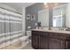 Bathroom featuring double sink vanity, tiled floor, a shower with gray and white curtain at 160 Ocean Commons Dr., Surfside Beach, SC 29575