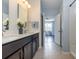 Double sink bathroom with a white countertop and dark wood cabinets, with a view to the bedroom at 160 Ocean Commons Dr., Surfside Beach, SC 29575