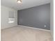 Bedroom with carpeted floors, one gray wall, and a window with white blinds at 160 Ocean Commons Dr., Surfside Beach, SC 29575