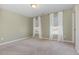 Bright bedroom with neutral walls, carpeted floors, and two windows with white curtains at 160 Ocean Commons Dr., Surfside Beach, SC 29575