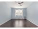 Empty bedroom with light blue walls, wood-look flooring, and a ceiling fan at 160 Ocean Commons Dr., Surfside Beach, SC 29575