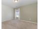 Empty bedroom with neutral walls, plush carpeting, and window with sheer white curtains at 160 Ocean Commons Dr., Surfside Beach, SC 29575