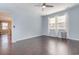 Light-filled bedroom featuring light blue walls, hardwood floors, and views to a dining room at 160 Ocean Commons Dr., Surfside Beach, SC 29575