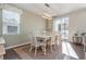 Bright dining room with a wooden table, six chairs, and stylish lighting fixture at 160 Ocean Commons Dr., Surfside Beach, SC 29575