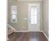 Inviting entryway featuring hardwood floors, a glass-paneled door, and a staircase at 160 Ocean Commons Dr., Surfside Beach, SC 29575