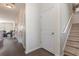 Hallway with dark wood floors leading to living area and carpeted stairs to upper level at 160 Ocean Commons Dr., Surfside Beach, SC 29575