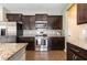 Well-equipped kitchen featuring stainless steel appliances, dark cabinets, and granite countertops at 160 Ocean Commons Dr., Surfside Beach, SC 29575