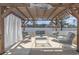 Under a covered pergola, this outdoor patio seating area is equipped with cushioned chairs and a center coffee table at 160 Ocean Commons Dr., Surfside Beach, SC 29575