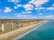 Breathtaking aerial view showcasing the coastline with sandy beach and city buildings against the bright blue sky at 1625 S Ocean Blvd. # 1810, North Myrtle Beach, SC 29582