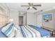 Comfortable main bedroom with ensuite bathroom access, a television, and a soothing color palette at 1625 S Ocean Blvd. # 1810, North Myrtle Beach, SC 29582