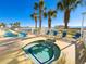 A sunny outdoor pool deck featuring a long pool, a hot tub, and a view of the ocean at 1625 S Ocean Blvd. S # 910, North Myrtle Beach, SC 29582