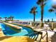 A sunny outdoor pool deck featuring a long pool, a hot tub, and a view of the ocean at 1625 S Ocean Blvd. S # 910, North Myrtle Beach, SC 29582