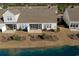 An aerial view featuring a home with a screened porch, patio, and pond views at 179-A Parmelee Dr. # A, Murrells Inlet, SC 29576