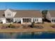 A view of the backyard, with a pond and landscaping at 179-A Parmelee Dr. # A, Murrells Inlet, SC 29576