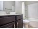 A clean bathroom featuring a single sink vanity, a white toilet and a tub with a shower at 179-A Parmelee Dr. # A, Murrells Inlet, SC 29576