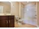 A well lit bathroom featuring a single sink vanity, a white toilet and a tub with a shower at 179-A Parmelee Dr. # A, Murrells Inlet, SC 29576