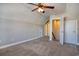 This bedroom features carpeted floors, a ceiling fan, and a door leading to the attic at 179-A Parmelee Dr. # A, Murrells Inlet, SC 29576