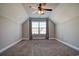 This bedroom features carpeted floors, a ceiling fan, and a window for natural light at 179-A Parmelee Dr. # A, Murrells Inlet, SC 29576