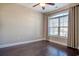 This bedroom features hardwood floors, a ceiling fan, and a large window for natural light at 179-A Parmelee Dr. # A, Murrells Inlet, SC 29576