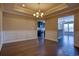 A dining room with elegant wainscoting, hardwood floors, and chandelier at 179-A Parmelee Dr. # A, Murrells Inlet, SC 29576