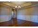 A dining room with wainscoting, hardwood floors, and chandelier at 179-A Parmelee Dr. # A, Murrells Inlet, SC 29576