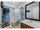 Bright bathroom featuring a shower and bathtub combo with blue walls and decorative shelving unit at 182 Tibton Circle, Myrtle Beach, SC 29588