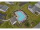 Aerial view of a community pool surrounded by lounge chairs, umbrellas, and lush landscaping at 182 Tibton Circle, Myrtle Beach, SC 29588